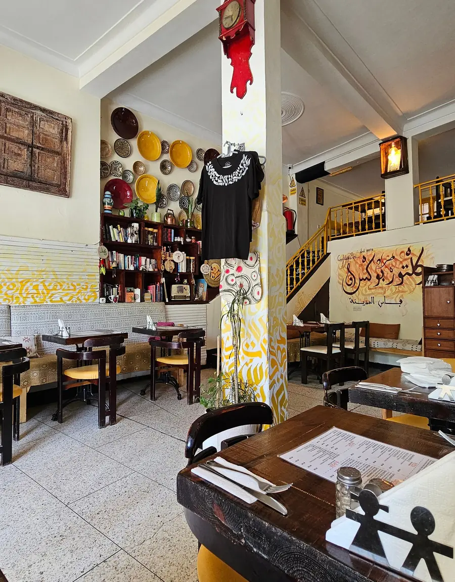 Tiled dining room with painted calligraphy column at Culture Box